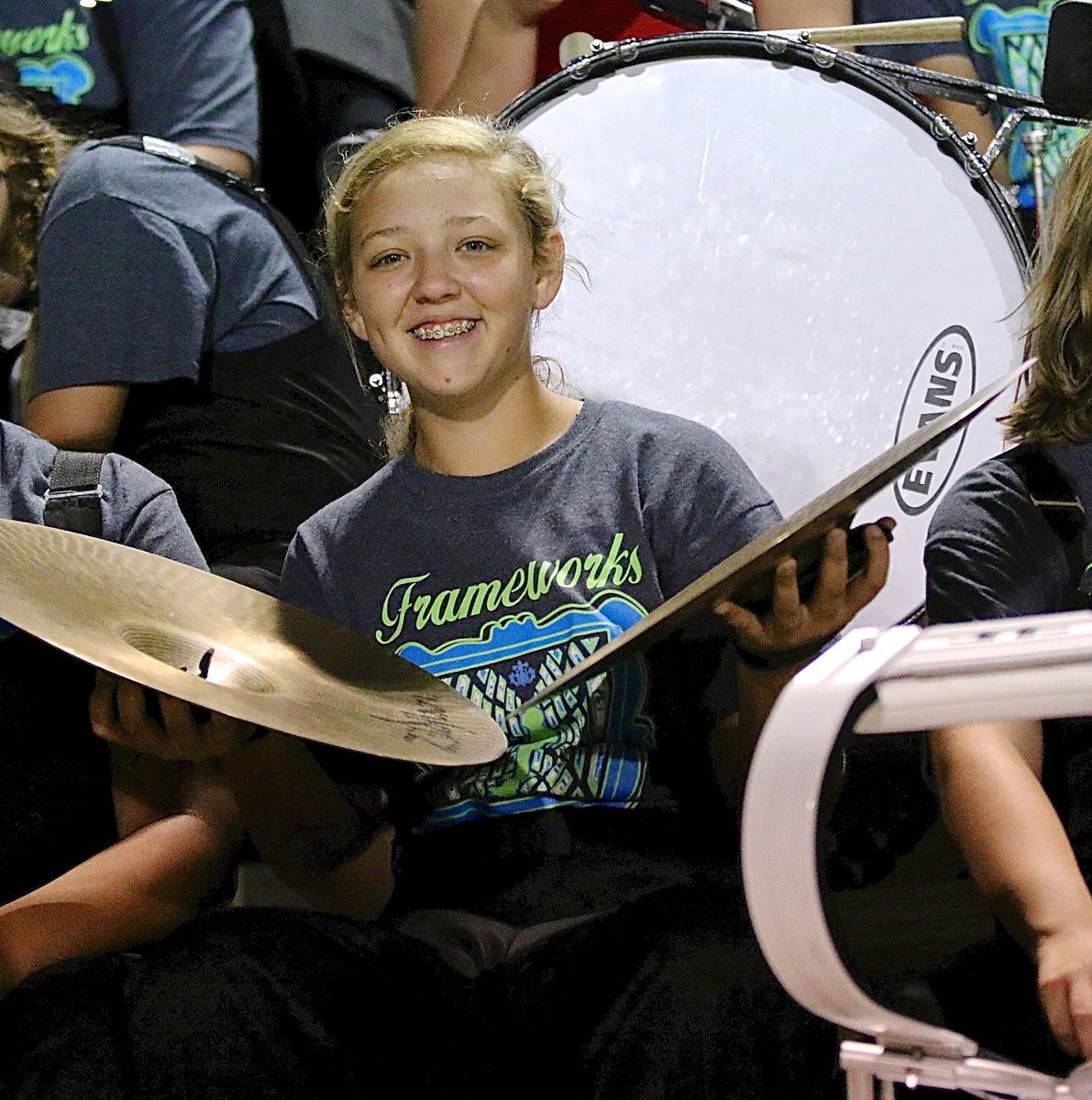 Image: Brycelyn Richards uses the symbols to make some noise during homecoming.