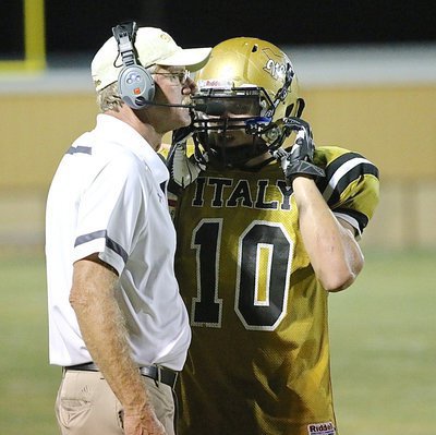 Image: Gladiator head coach Charles Tindol sends the play in with Coby Jeffords(10).