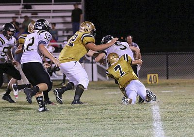 Image: Gladiator Ryan Connor(7) sacks Dawson’s quarterback from his safety position with teammate Aaron Pittmon(72) backing Connor up.