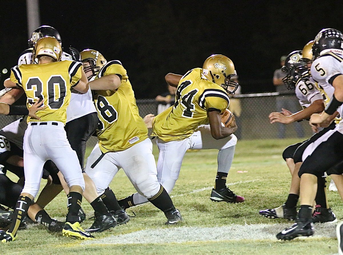 Image: Gladiators Hunter Ballard(30) and Sam Corley(58) execute a double-team block allowing Jaray Anderson to slip thru for extra yards.