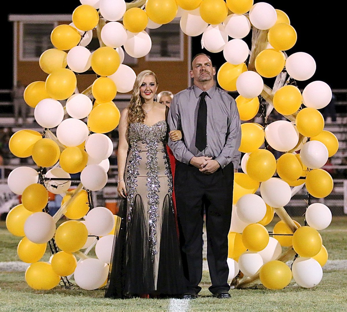 Image: Homecoming Queen Nominee Kelsey Nelson, a senior, is escorted by her father, Doug Nelson.