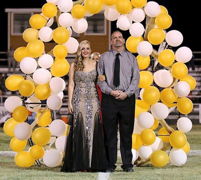 Image: Homecoming Queen Nominee Kelsey Nelson, a senior, is escorted by her father, Doug Nelson.
