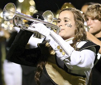 Image: Amber Hooker sounds the Gladiator charge during halftime.
