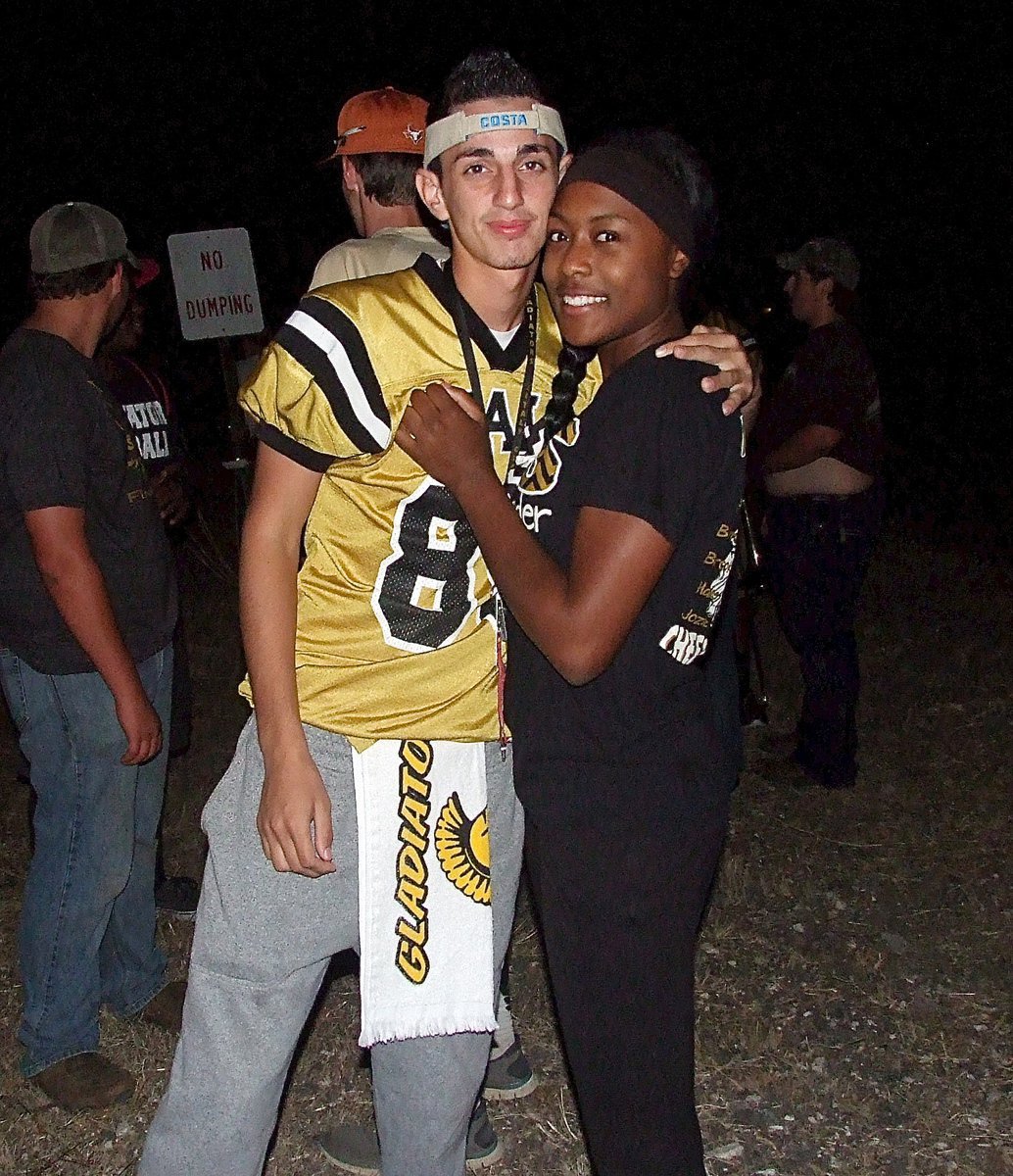 Image: Jack Hernandez(80) and K’Breona Davis are ready to light the bonfire.