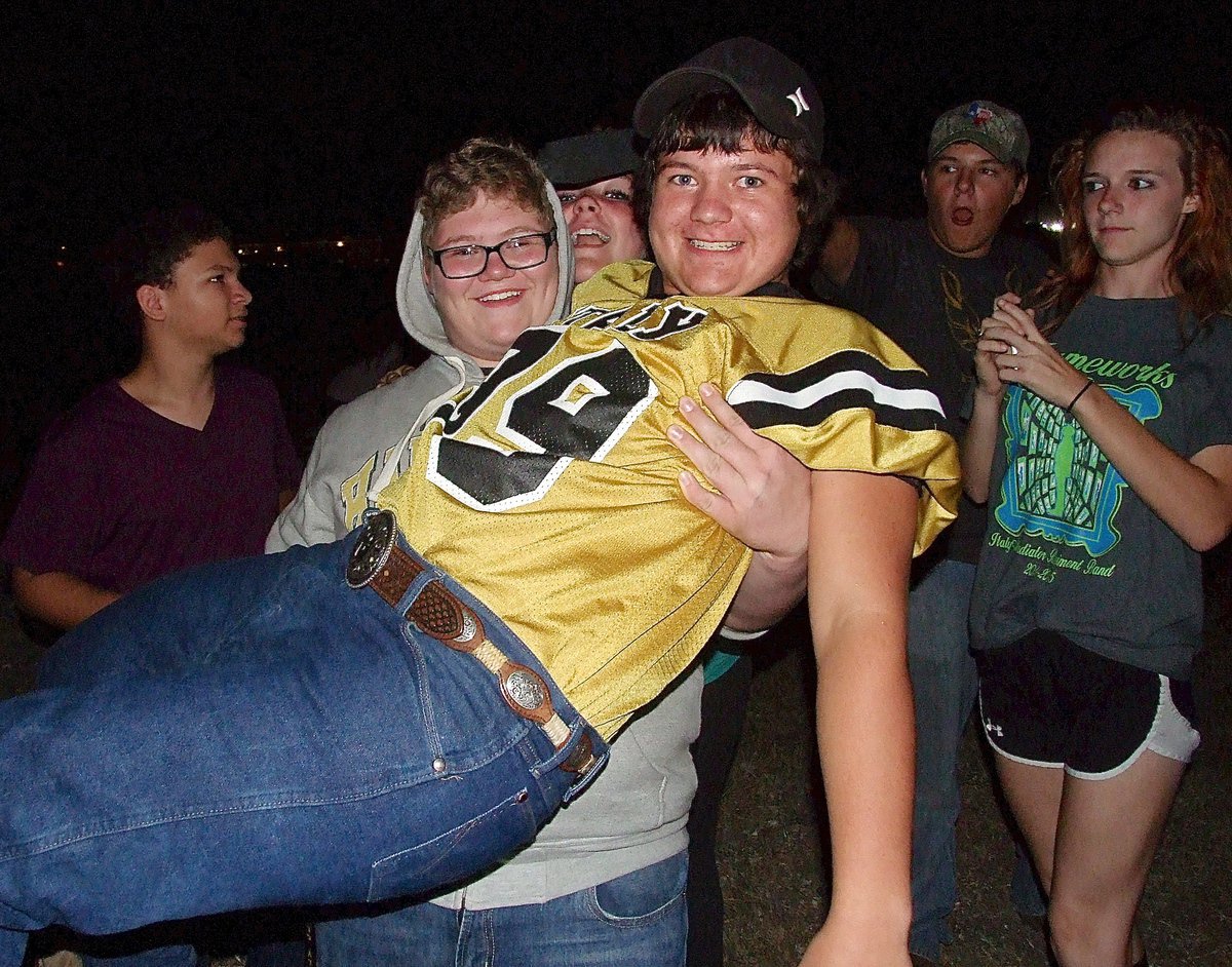 Image: Tomi Newman gives Barry Grant(99) a lift so he can see the bonfire better.