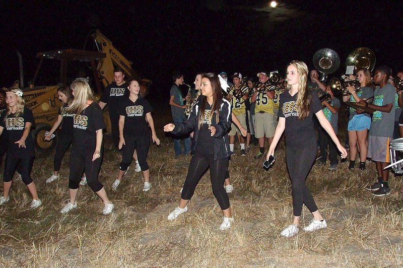 Image: The Italy High School cheerleaders perform a cheer as the band plays behind them in anticipation of lighting the homecoming bonfire.