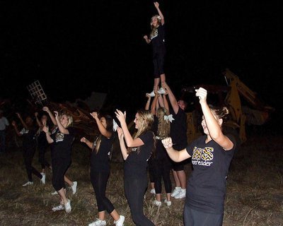 Image: Britney Chambers tops off a stunt as the cheer squad sparks Gladiator Nation.