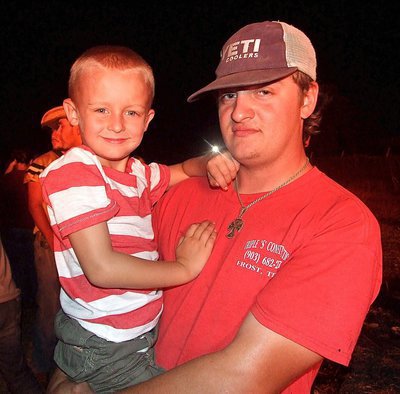Image: Kace and his dad Clayton enjoy the homecoming bonfire together. Kace is currently a member of the IYAA Football C-team Gladiators.