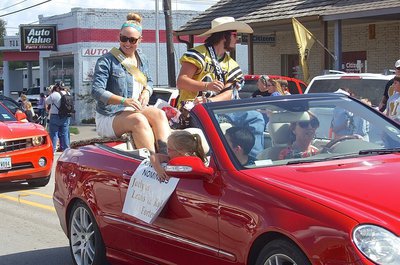 Image: Homecoming Queen Nominee Jaclynn Lewis and Homecoming King Nominee Kyle Fortenberry(66) are enjoying the parade while passing out candy.