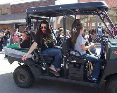 Image: Even the adults have fun being in the parade as driver Courtney Owens and candy thrower April Mathers share in the excitement.