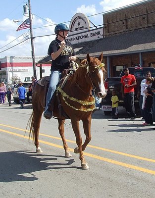 Image: Julie Hinz, ranch manage at Flying Dollar Ranch of Italy, saddled up for the homecoming parade.