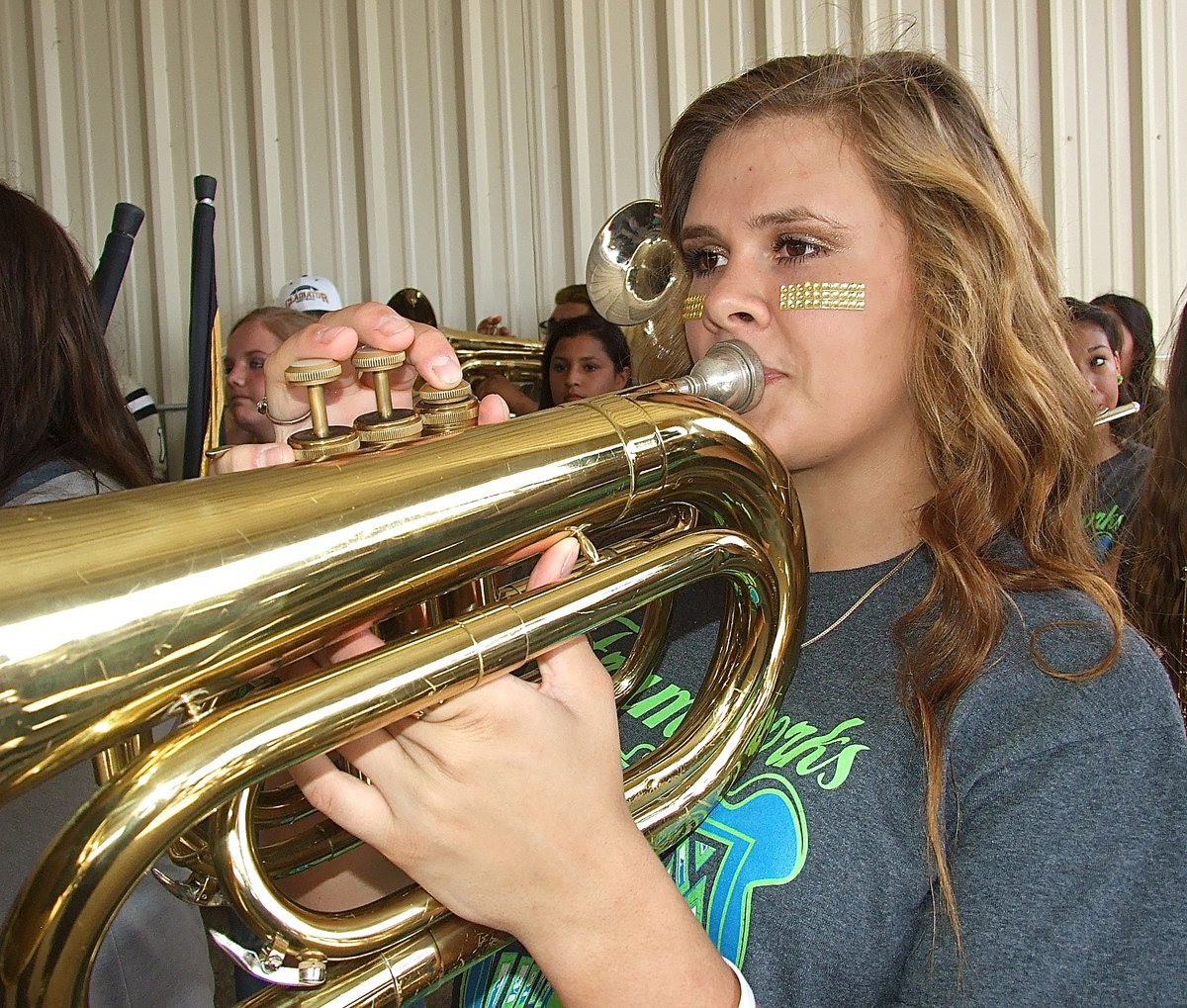 Image: Lille Perry sounds the war hymn, summoning Gladiator Nation to the pavilion.