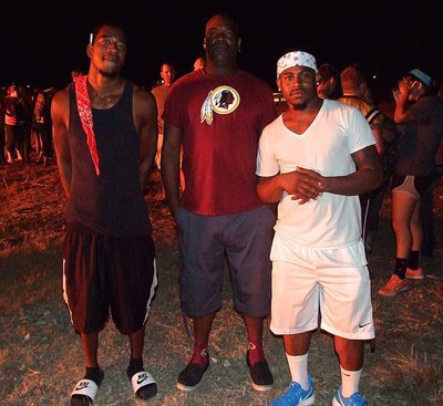 Image: Butter, Kenneth and Jamal supporting the Gladiators during the bonfire.