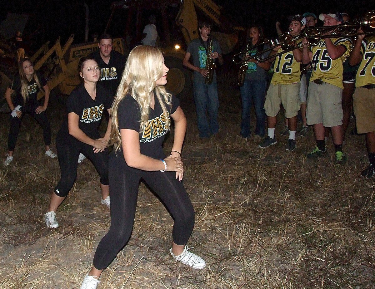 Image: Cheerleaders Annie Perry, Brooke DeBorde, Zac Mercer and Jozie Perkins perform a routine and the band plays loud and proud.