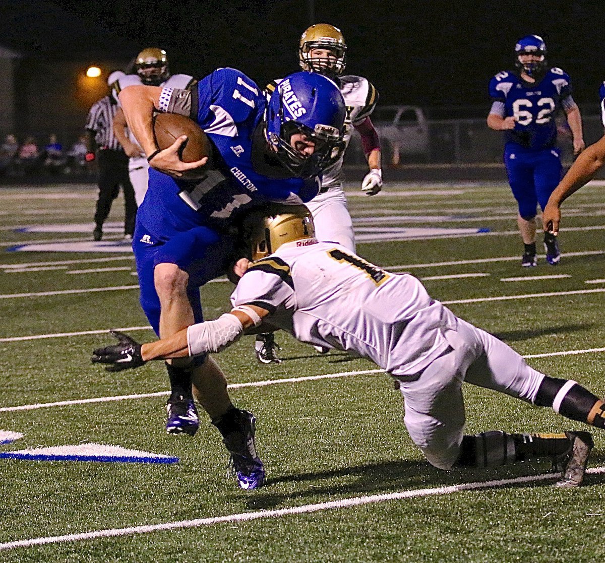 Image: Gladiator Levi McBride(1) attempts to leg tackle a Pirate runner.