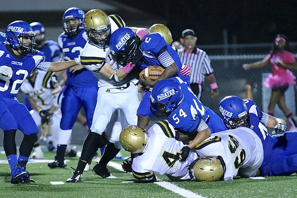 Image: Gladiator defenders Ryan Connor(7), Kendrick Norwood(4) and Kyle Fortenberry(66) pull down a Pirate ball carrier.