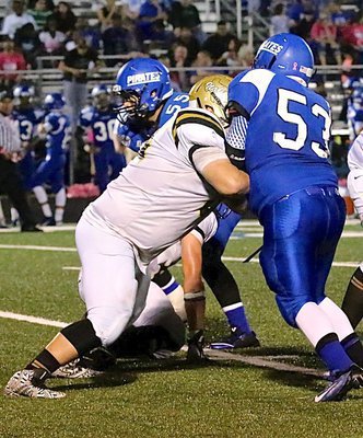 Image: Gladiator offensive tackle John Byers(60) keeps his man away from the ball.