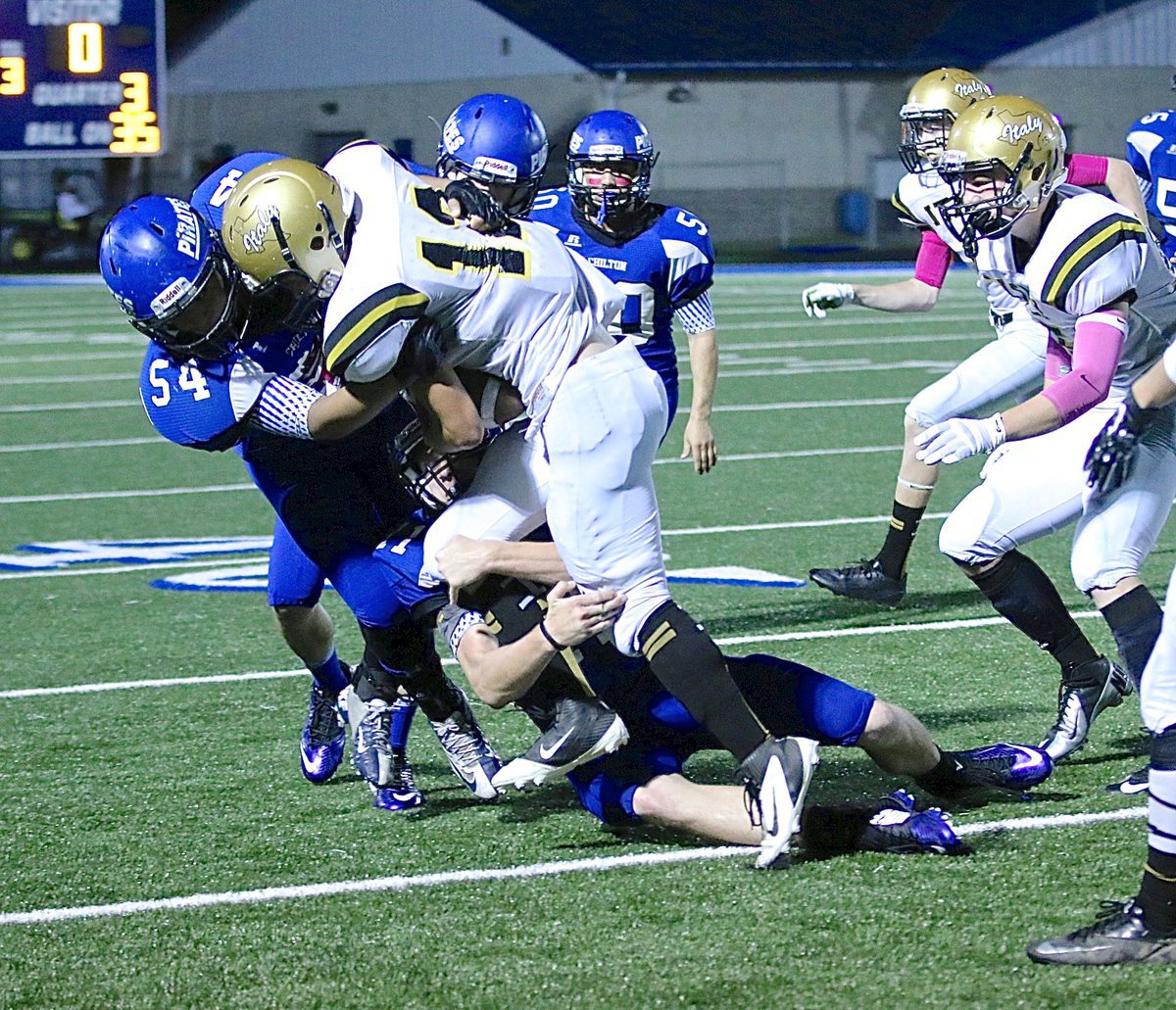 Image: Freshman Gladiator Kyle Tindol(12) powers over a Pirate tackler during a kick return.