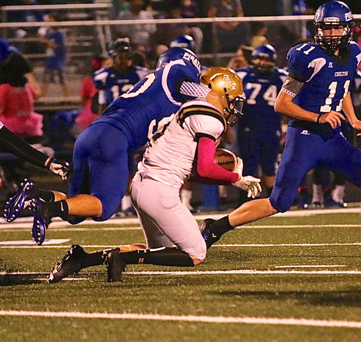 Image: Italy’s Clayton Miller(6) gets hogtied by a Pirate tackler during a kick return.