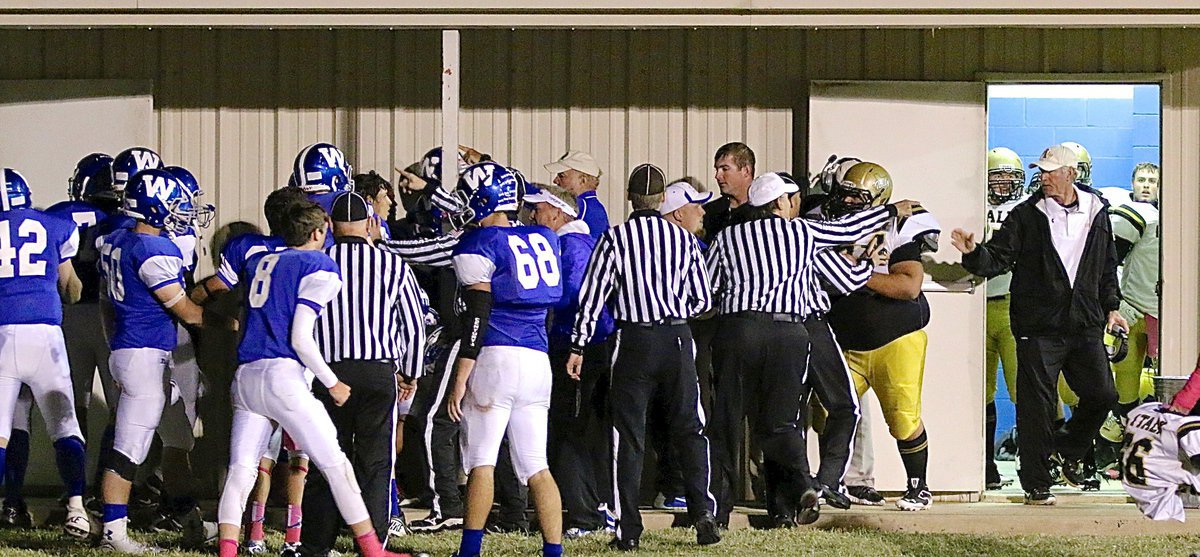 Image: Italy’s Ty Fernandez(64) steps out of the Gladiator locker room at halftime to wish the Wortham Bulldog team good luck in the second half.