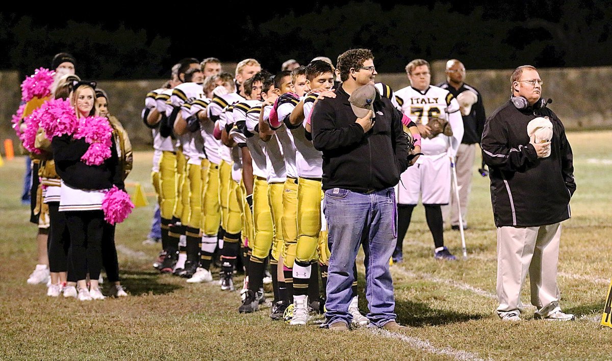 Image: The Gladiators, the coaches and the cheerleaders honor the flag.