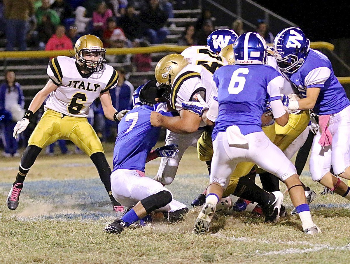 Image: Ty Fernandez(64) pancakes a defenseless Wortham defenseman as Fernandez leads the way on a quarterback sneak by teammate Joe Celis(8), resulting in a 1st down for Italy!