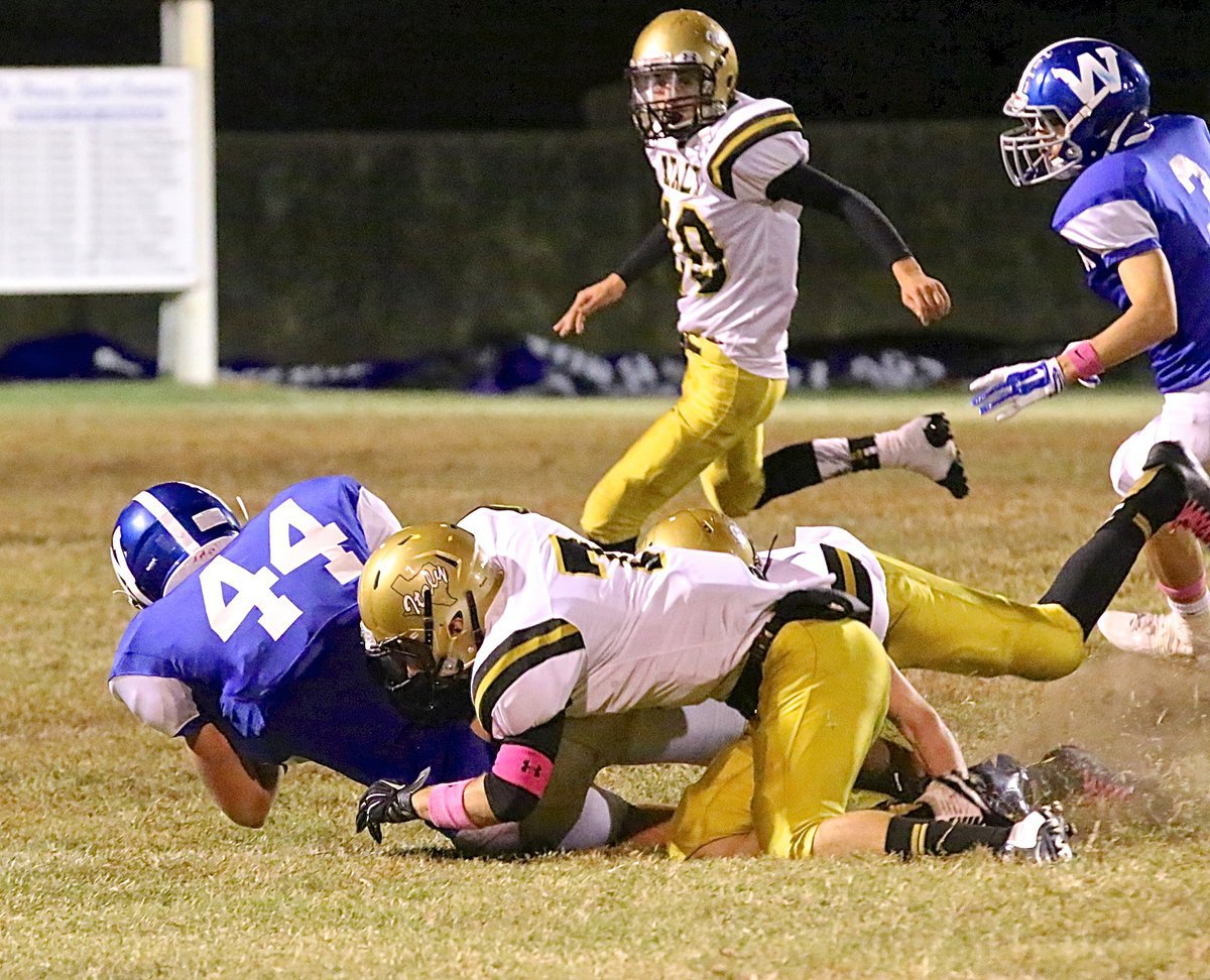 Image: Safety Ryan Connor(7) gets help from Clayton Miller(6) to pull down Wortham’s big tight-end.