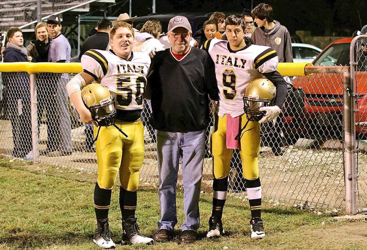 Image: Gary Sims from Alabama stands victorious with his Gladiator grandsons John Escamilla(50), a senior, and Gary Escamilla(9), a freshman.