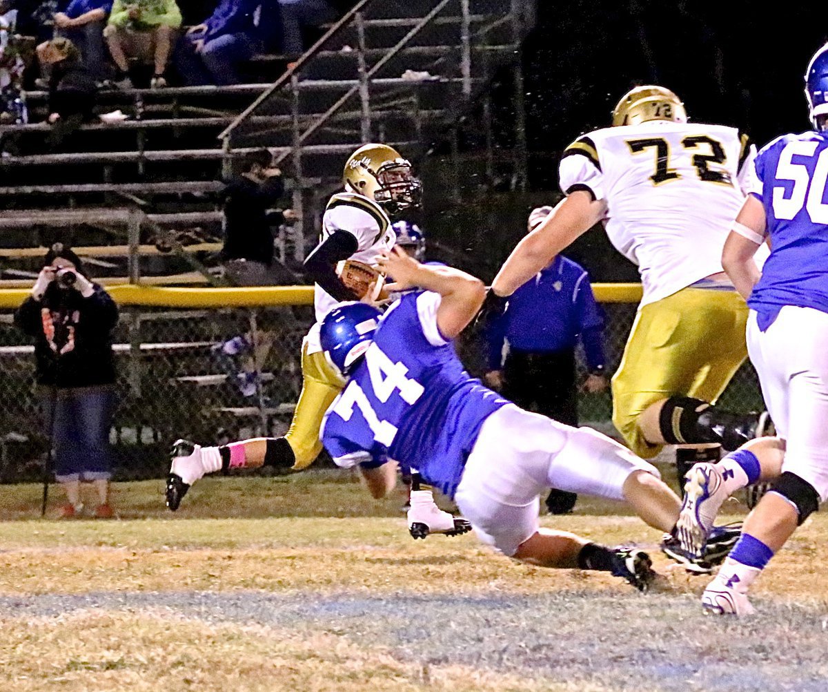 Image: Defensive tackle Aaron Pittmon(72) takes down an unsuspecting Bulldog to help safety Jack Hernandez(80) return a pick 33 yards.