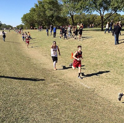 Image: Mason Womack finds the camera while representing Italy as the first male athlete from Italy to compete during a UIL regional cross country meet in recent times.