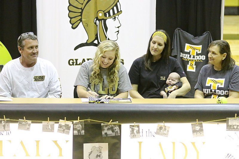 Image: Father and Italy ISD school board member Russ Lewis, sister Megann Lewis Harlow and her new son Renndon James Harlow and mother Kelly Lewis look on as Jaclynn Lewis begins signing her commitment letter to play softball for Texas Lutheran University.