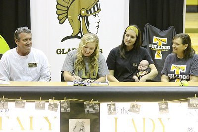 Image: Father and Italy ISD school board member Russ Lewis, sister Megann Lewis Harlow and her new son Renndon James Harlow and mother Kelly Lewis look on as Jaclynn Lewis begins signing her commitment letter to play softball for Texas Lutheran University.