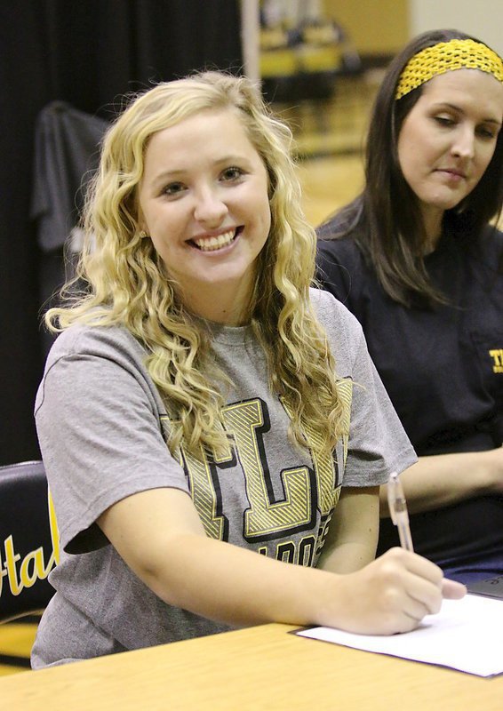 Image: Jaclynn Lewis is unable to contain her smile while officially committing to Texas Lutheran while big sis Megann Lewis Harlow, a former collegiate pitcher, watches over her Jac.