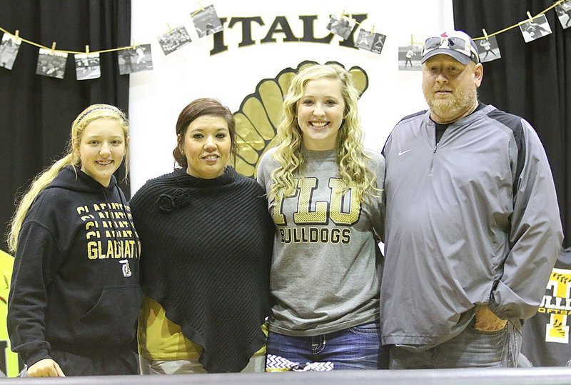Image: Jaclynn Lewis poses with the Richards family which includes teammate Brycelyn Richards, Italy head softball coach Tina Richards and her husband (and one of Jaclynn’s hitting coaches) Allen Richards.