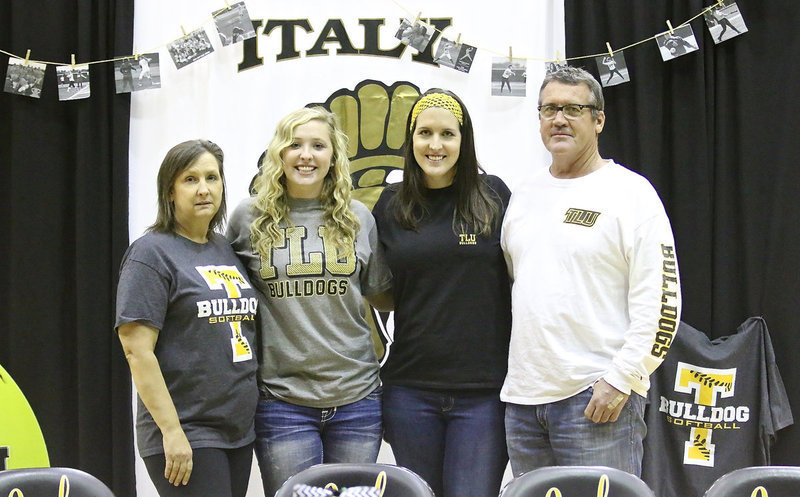 Image: Jaclynn Lewis with her mother Kelly Lewis, her big sister Megann Lewis Harlow and father Russ Lewis after Jac committed to play her collegiate softball for the Texas Lutheran University Lady Bulldogs.