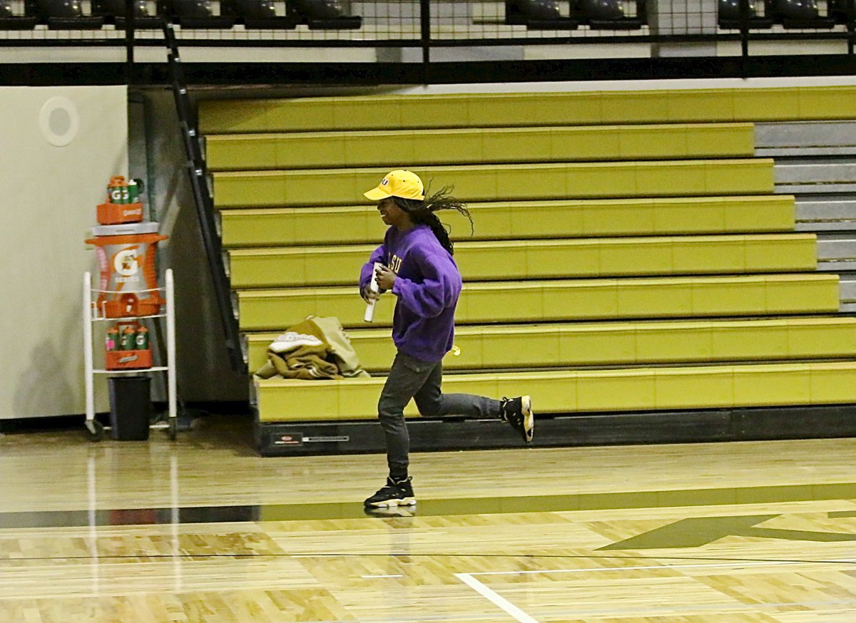 Image: Kortnei Johnson takes a victory lap around the gym floor of Italy Coliseum since track has propelled the senior to the world collegiate level track. Johnson will join the LSU Lady Tigers in 2015.