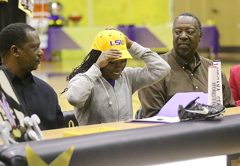 Image: She knew it all along! Kortnei Johnson slips on an LSU ball cap and then unzips her jacket to reveal an LSU sweatshirt after making her college choice.