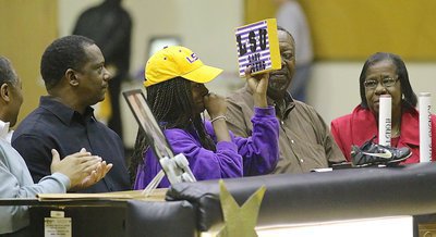 Image: Kortnei Johnson admires a congratulatory gift with LSU Lady Tigers displayed proudly on the front.