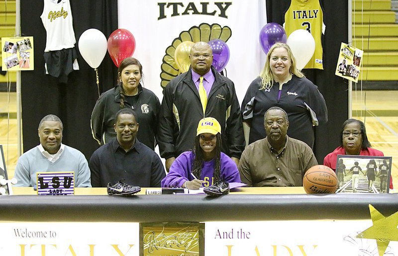 Image: Italy High School senior Kortnei Johnson signs her letter of intent to run track for the D1 LSU Lady Tigers in 2015. Coaches and family members joined Johnson inside Italy Gladiator Coliseum for her special moment. Back row (L-R): Coaches Tina Richards, Bobby Campbell and Melissa Fullmer. Front row (L-R): Summer track coach Keith Herring, father James Johnson, Kortnei Johnson herself, Uncle Danny Jennings and aunt Wanda Jennings.
