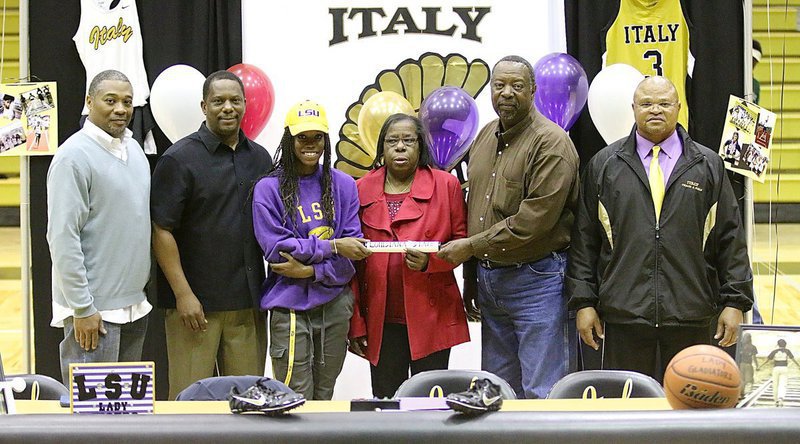 Image: Summer track coach Keith Herring, father James Johnson, Kortnei Johnson, aunt Wanda Jennings, uncle Danny Jennings and track coach Bobby Campbell have all had a hand in Johnson reaching her dreams of being a collegiate track athlete for LSU and possibly an olympian at some point.