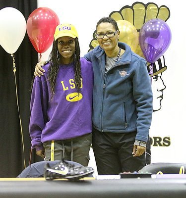 Image: Kortnei Johnson gets congratulated by Jane Laws after Johnson signed to run collegiate level track for the LSU Lady Tigers.