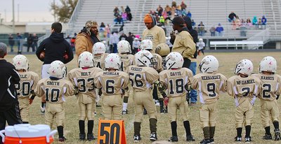 Image: The IYAA C-Team Gladiators lineup for the ceremonial coin toss prior to the Superbowl kickoff.