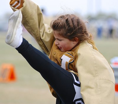 Image: IYAA B-Team cheerleader Mayson Souder tries to give her Gladiator a leg up in the Superbowl over the Blooming Grove Lions