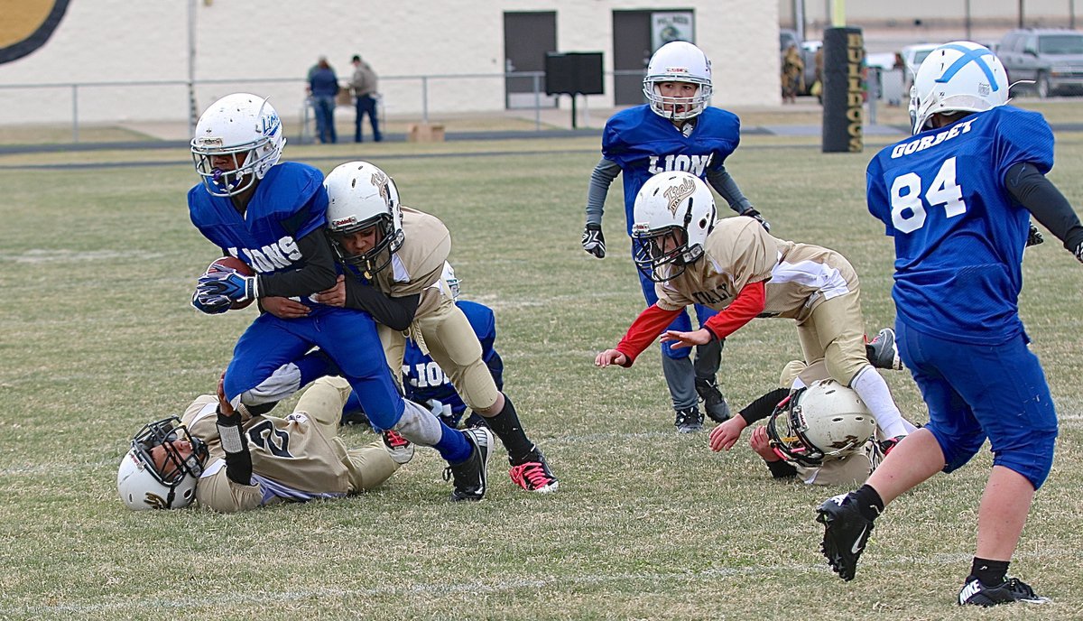 Image: IYAA B-Team Gladiators Jaylon Wallace(2) and Gabe Martinez(5) team up to bring down Blooming Grove’s main weapon.