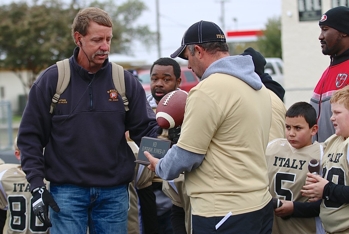 Image: IYAA President Charles Hyles presents B-Team Coach Mark Souder, his coaching staff and his 11 total players with the 2014 NEH Superbowl Runner-Up trophy. What an accomplishment!!!