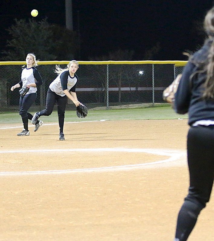Image: Third-baseman Brycelen Richards throws to fellow freshman Jenna Holden at first-base for an Italy out.
