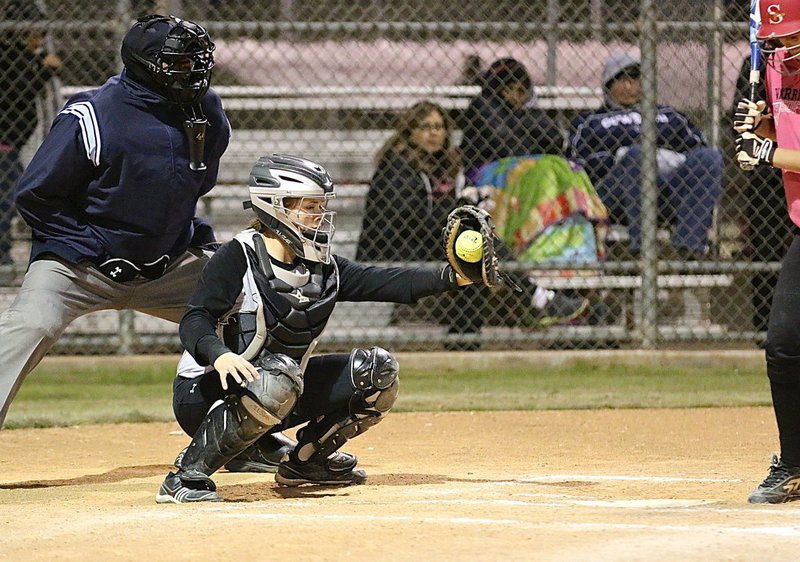 Image: Catcher Lillie Perry squeezes a strike from her pitcher, Jaclynn Lewis.