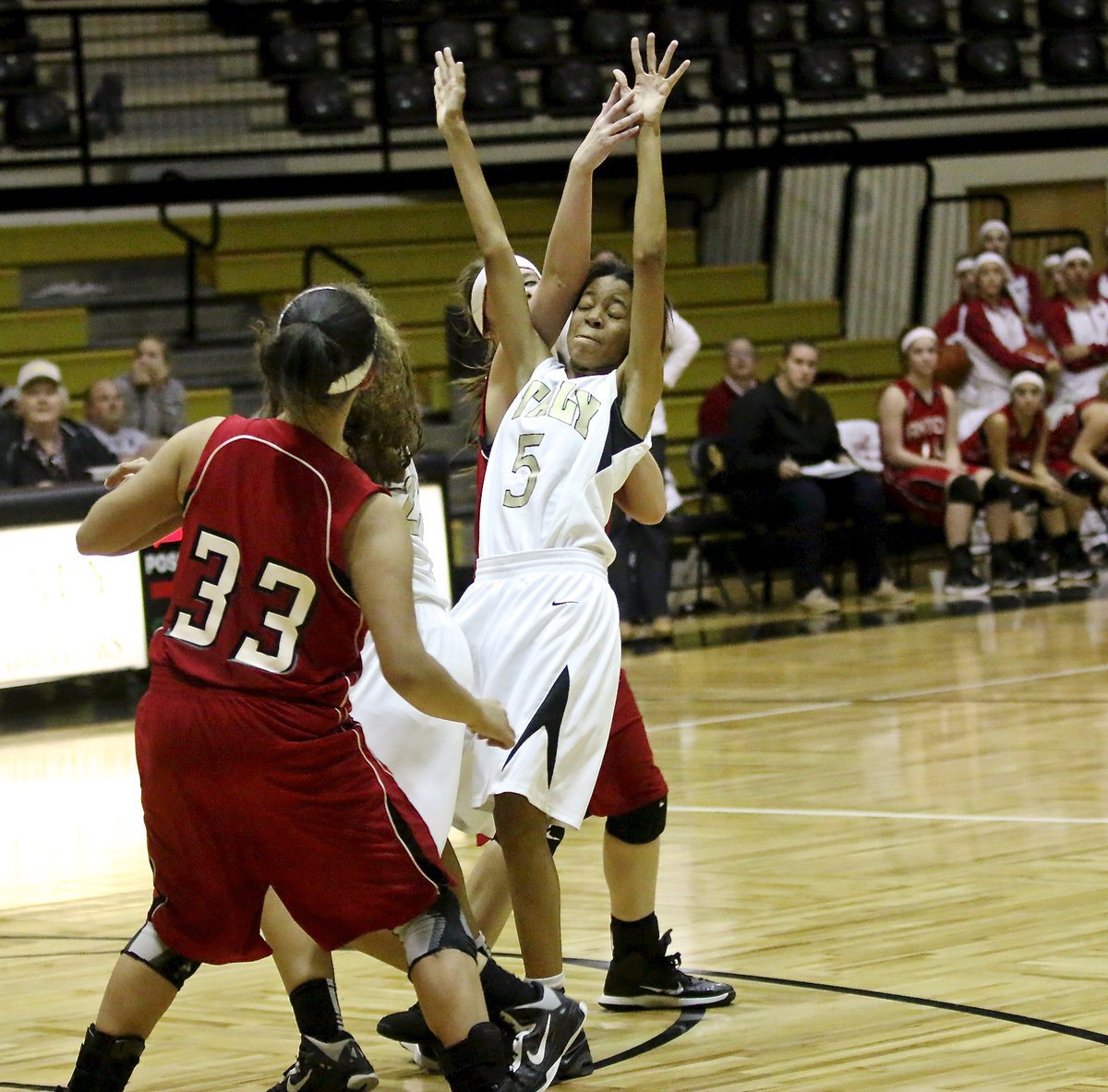 Image: Down to three players T’Keyah Pace(5) and Vanessa Cantu(24) give it all they have while going for a loose ball in the lane.