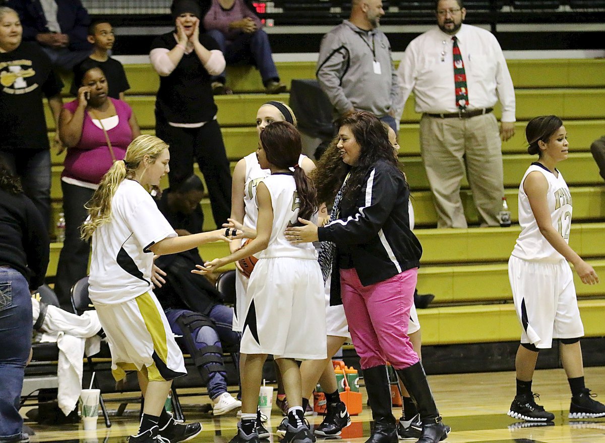 Image: Varsity Lady Gladiator freshman Brycelen Richards rushes onto the floor to congratulate the JV Lady Gladiators after their win over Axtell. Italy started with 5 players but finished with 3 and still managed to defeat Axtell 23-21 Tuesday night in the Coliseum.