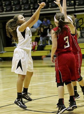 Image: Vanessa Cantu(24) takes a jumper from the elbow over two Axtell defenders.